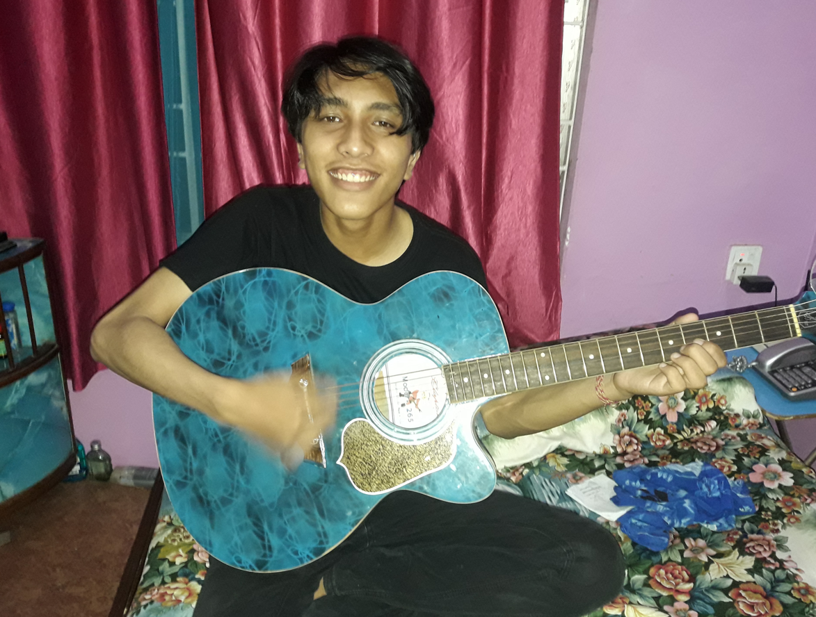 Nirdesh plays guitar